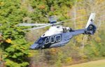 Canadian H160 flying with fall trees in background